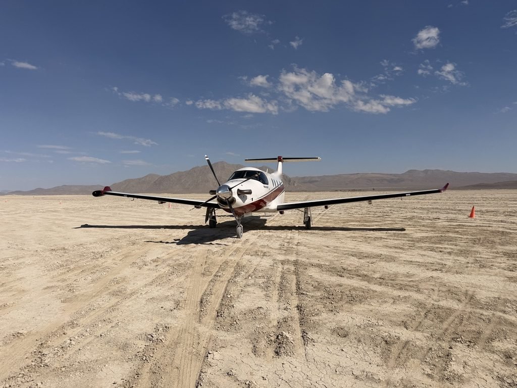 Pilatus PC-12 NG turboprop parked on a desert airstrip